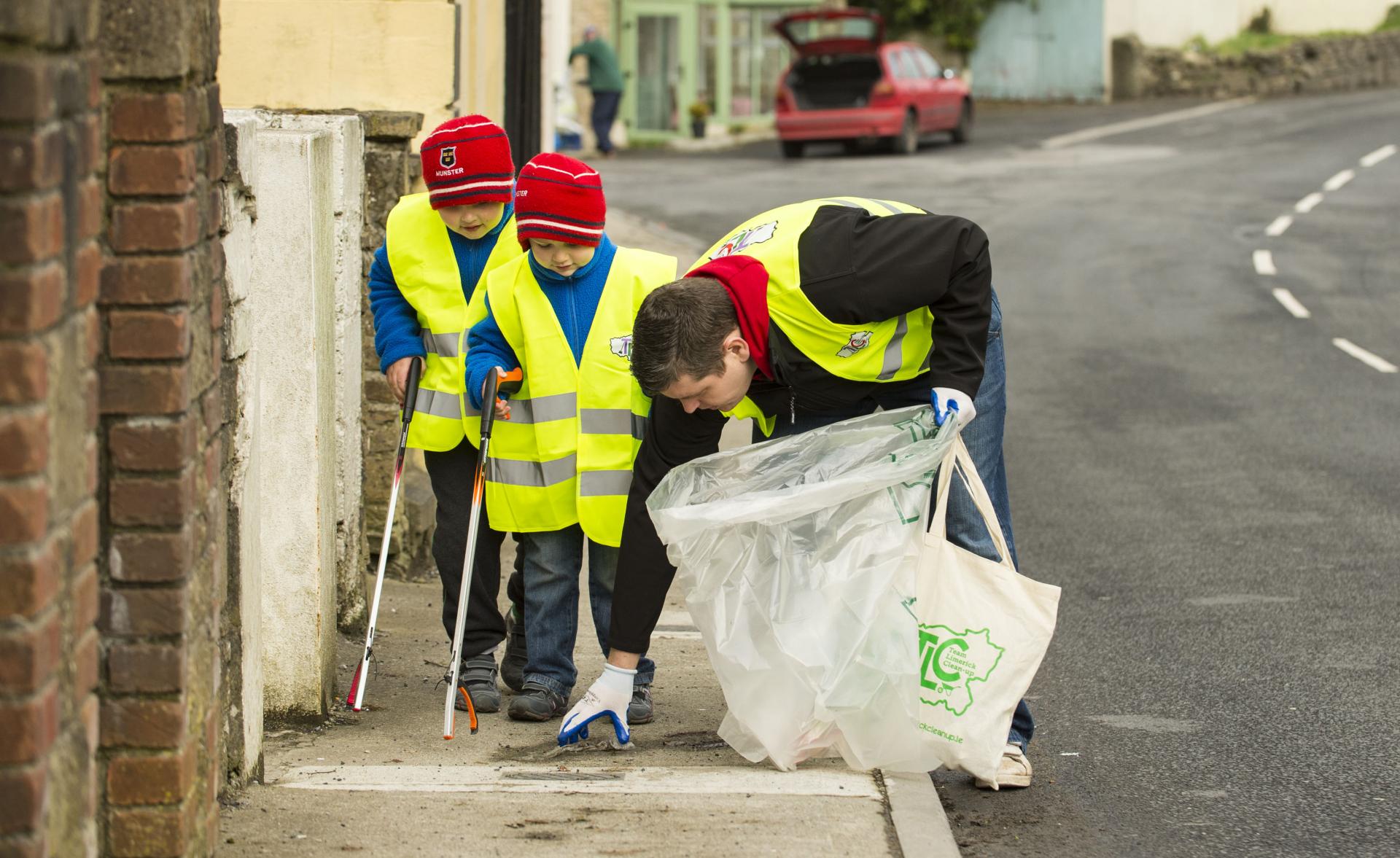 A man with two young boys clean up at TLC
